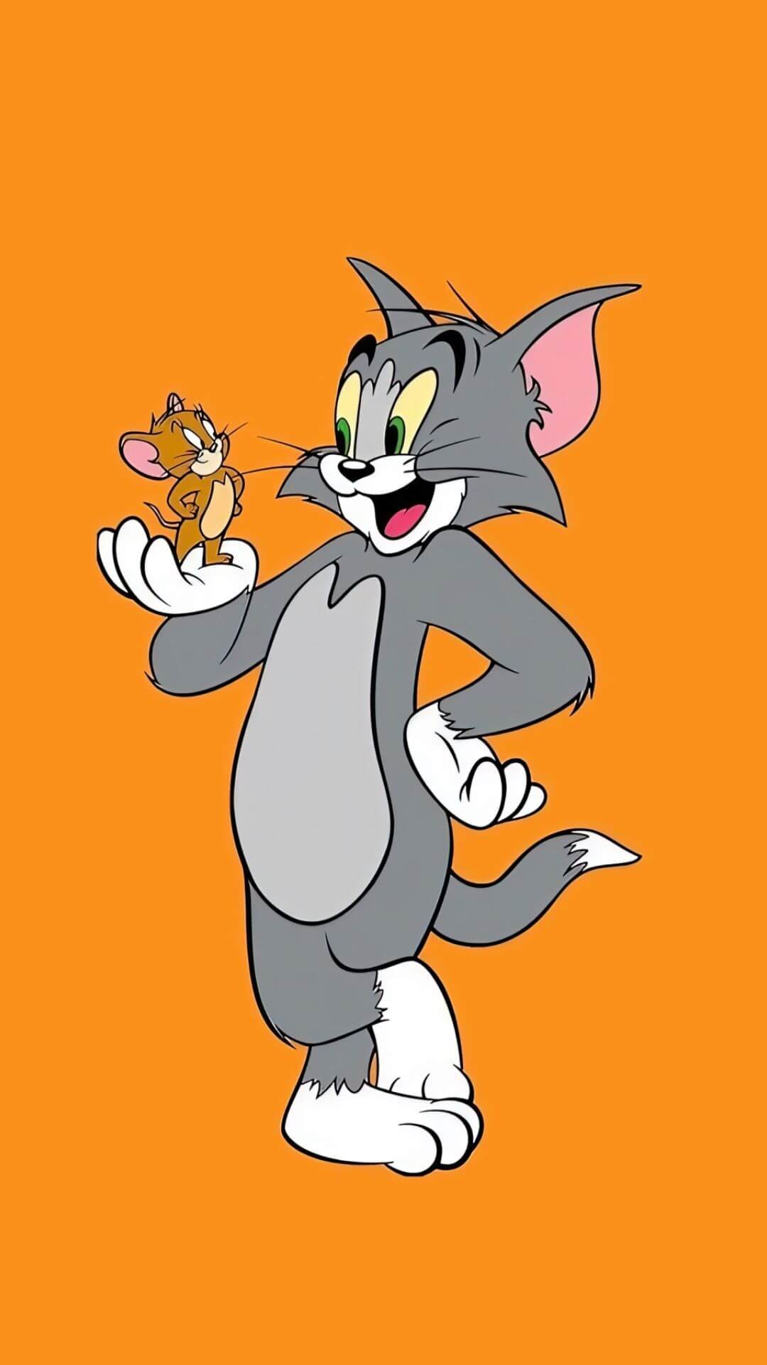 tom the grey cat holding jerry the brown mouse in his hand