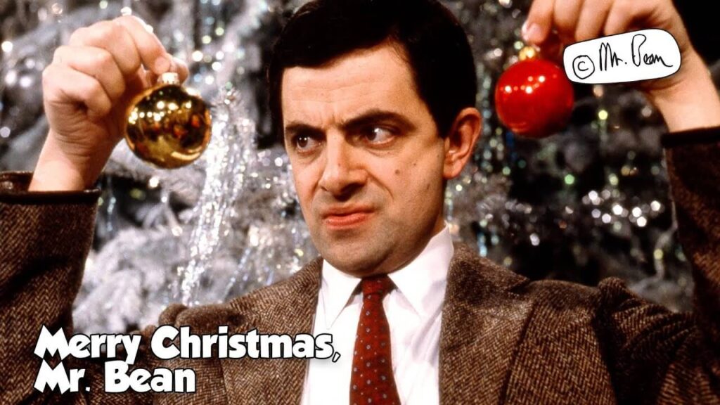 mr bean holding christmas lights and bells in hand