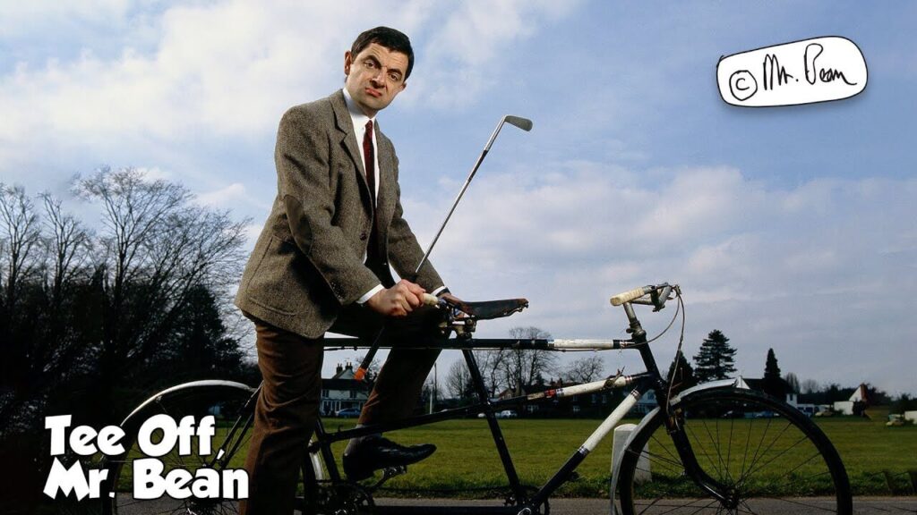 mr bean sitting on a cycle with a golf club in his hand