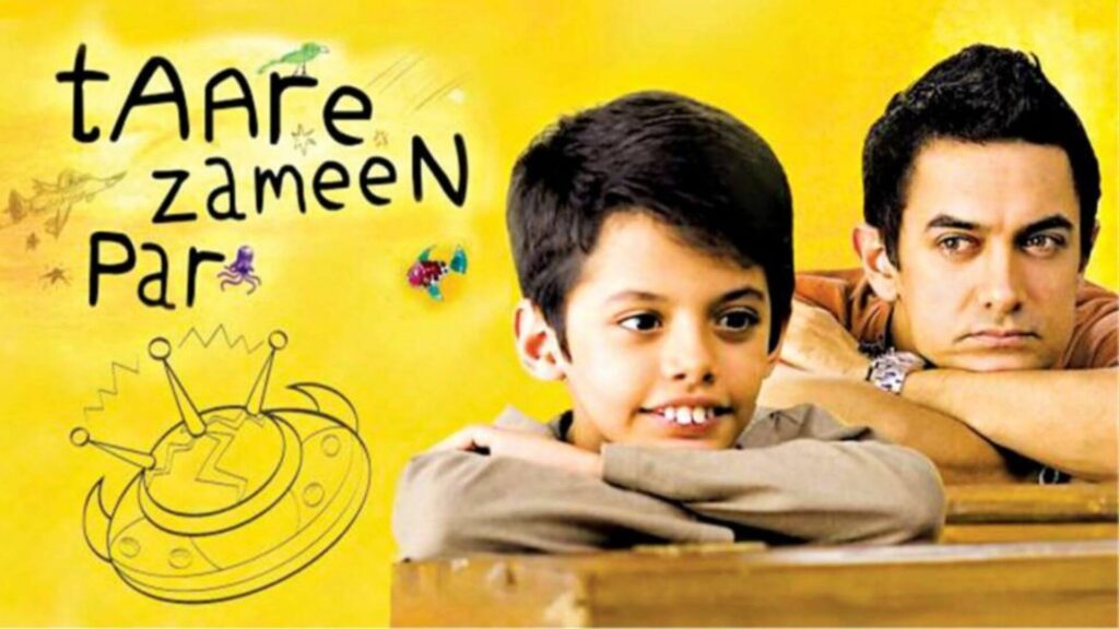 amir khan sitting with ishaan awasthi from taare zameen par on a bench in school